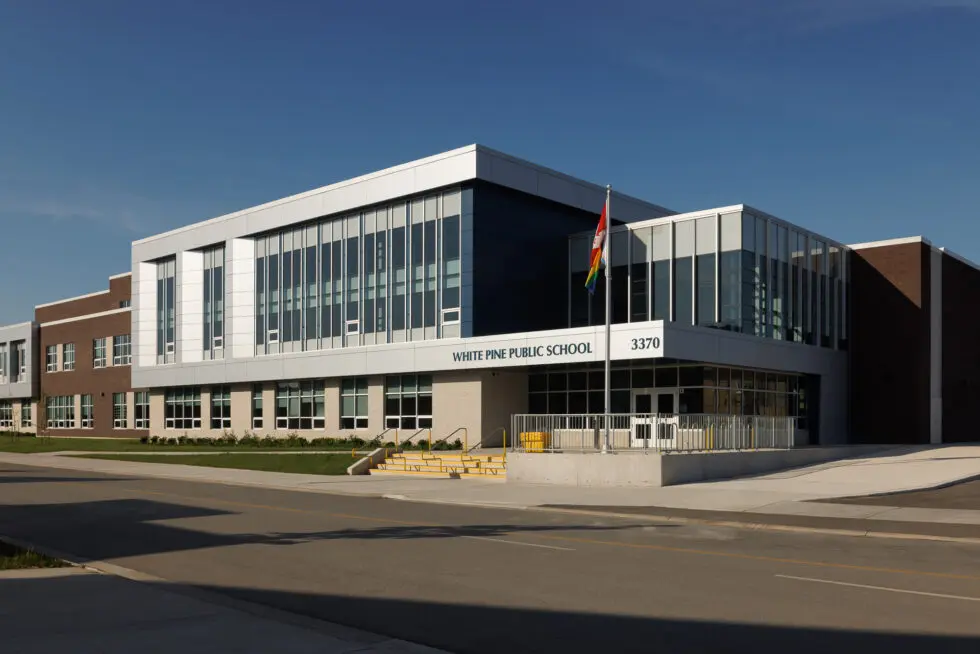 White Pine Public School building with modern architecture and rainbow flag