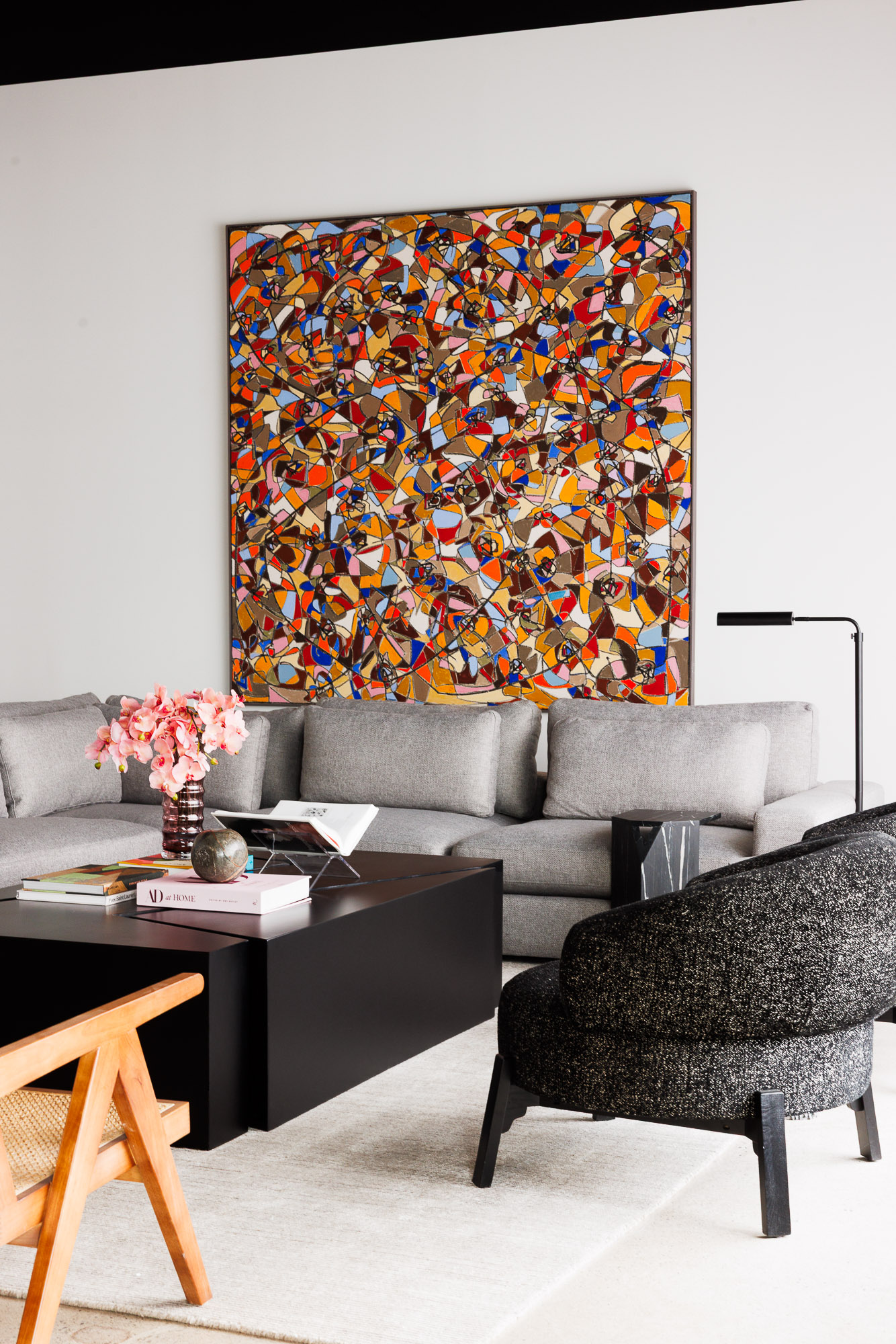 Contemporary Living Space with Abstract Art Spacious modern living area centered around a vibrant, large-scale abstract mosaic painting and modular sofa.